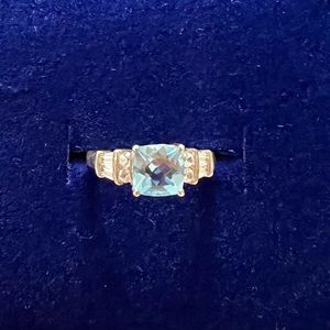 Blue Topaz set in Sterling Silver with eight side stones. Size approx 5.75.